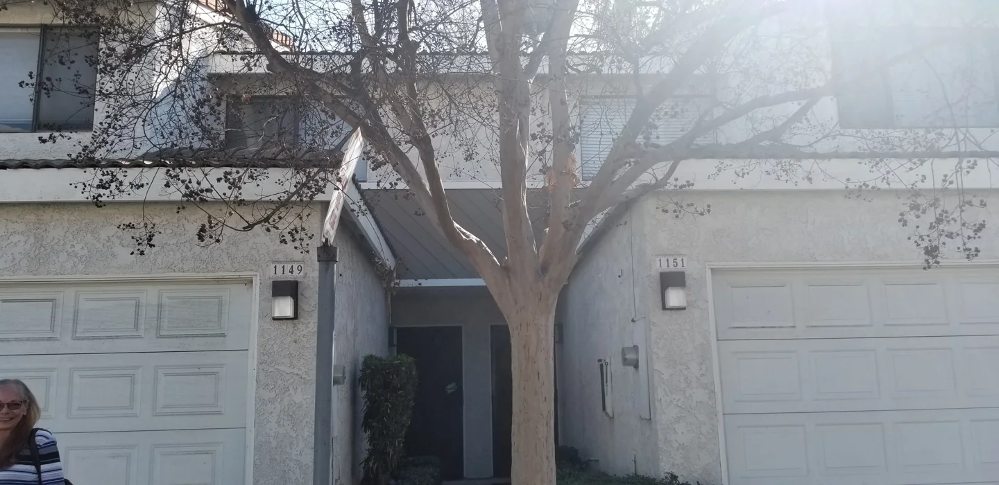 Wide front view of 1149 West Whittlers Lane in Ontario, California, showing the upper story, garage and recessed entrance beside the neighboring condo.
