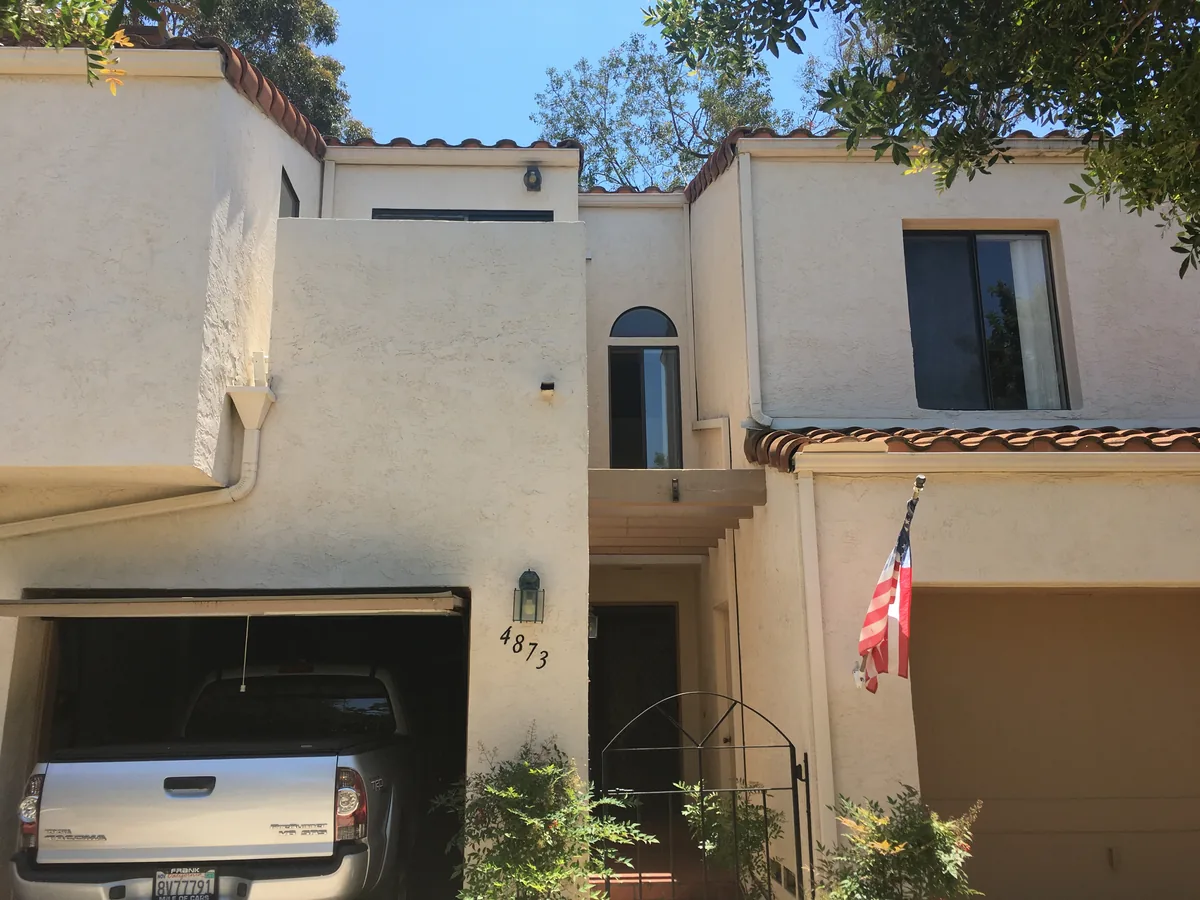 Front exterior of 4873 Seda Drive in San Diego, with a garage and upper-story window